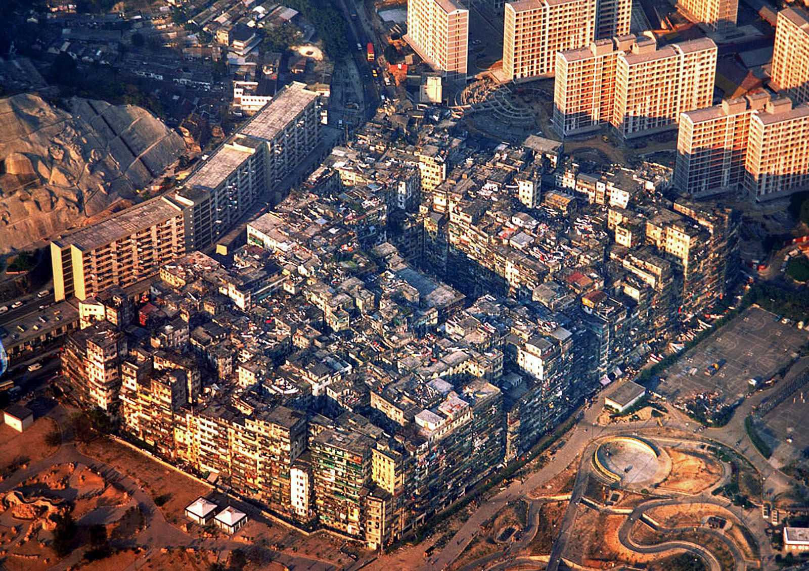 The walled city of Kowloon-Kowloon Walled City was a densely populated, largely ungoverned settlement in New Kowloon, Hong Kong. Originally a Chinese military fort, the Walled City became an enclave after the New Territories were leased to Britain in 1898. Its population increased dramatically following the Japanese occupation of Hong Kong during World War II. In 1987, the Walled City contained 33,000 residents within its 2.6-hectare "0.010 sq mi" borders. From the 1950s to the 1970s, it was controlled by Triads and had high rates of prostitution, gambling, and drug use.