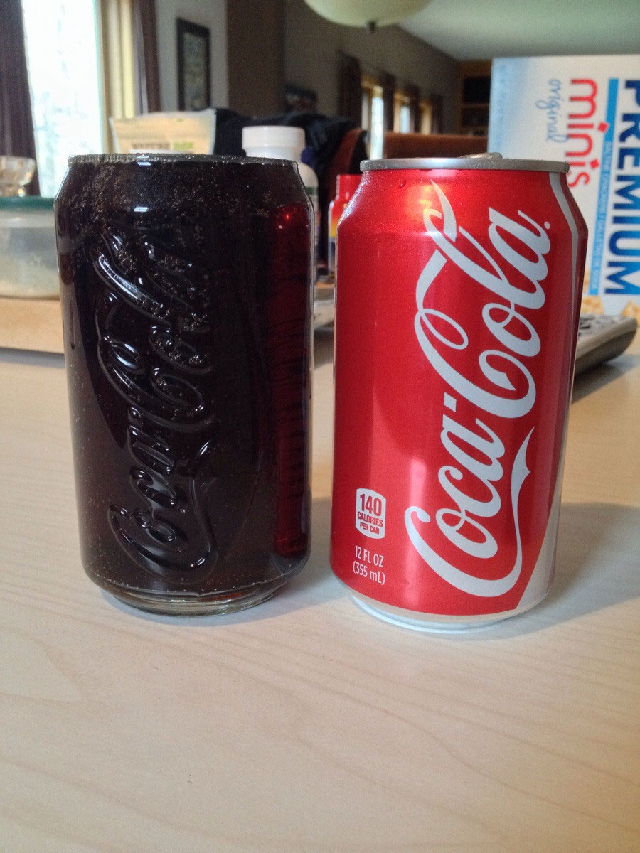 A can of soda that fits perfectly into a cup.