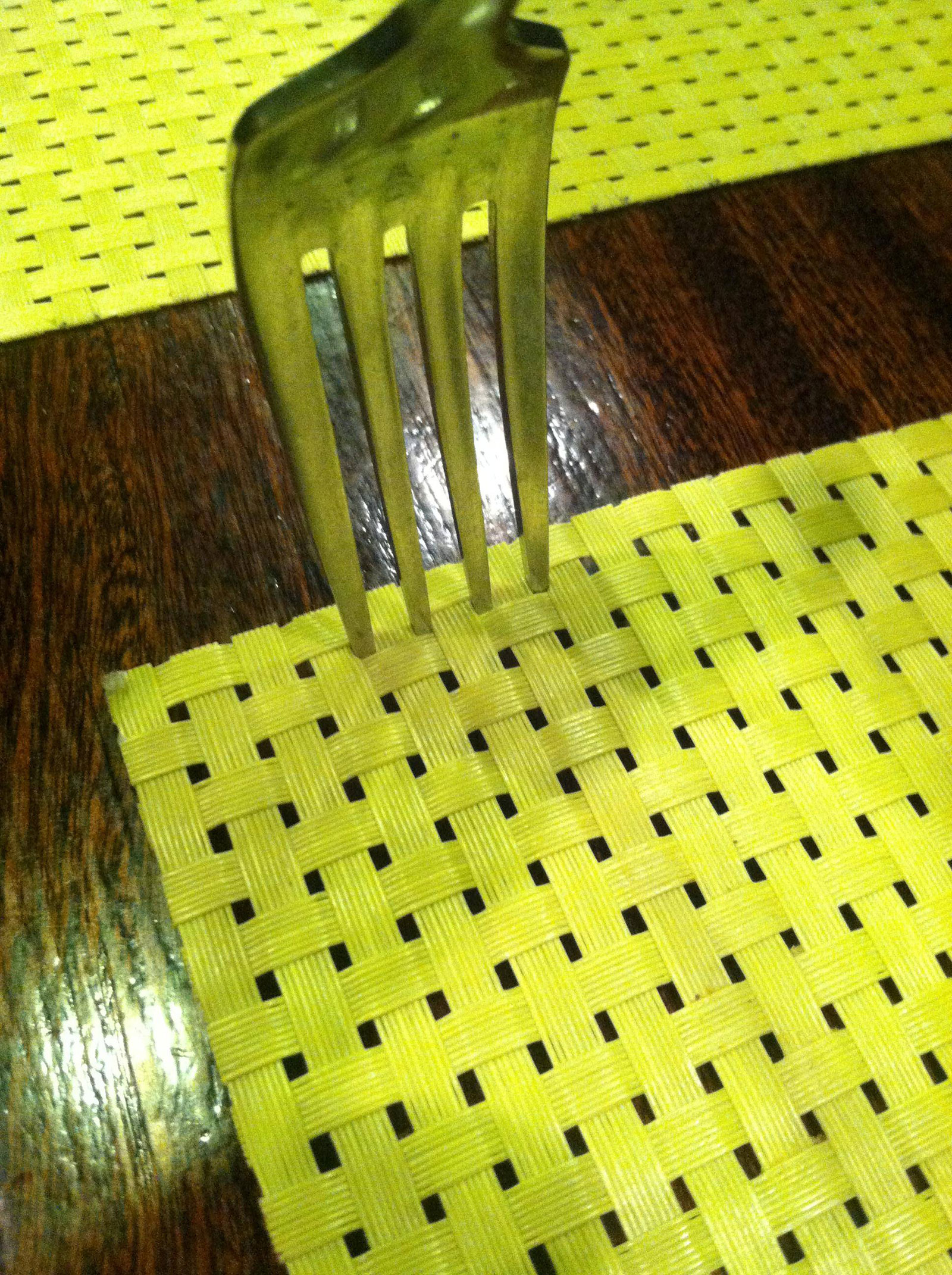 A fork that stuck right into a place mat.