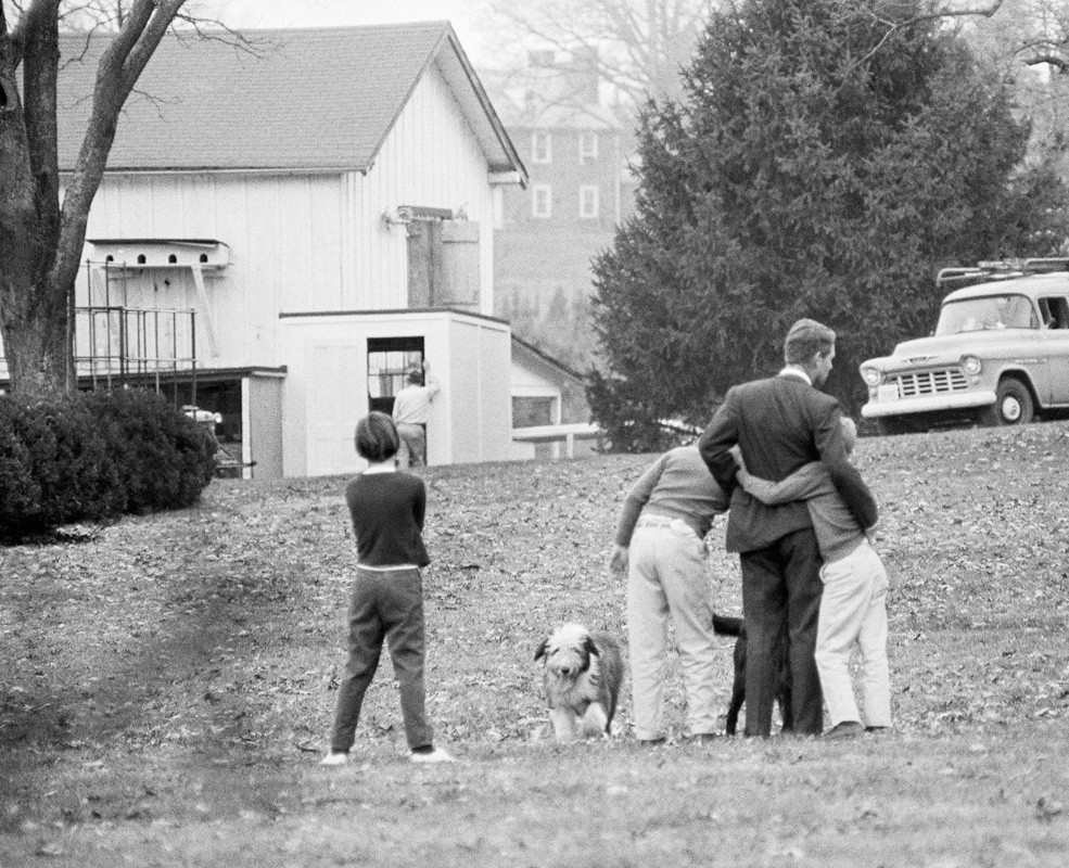 Attorney General Robert Kennedy is comforted by two of his children on the lawn of his home, after he had been notified of the assassination of his brother, November 22, 1963.