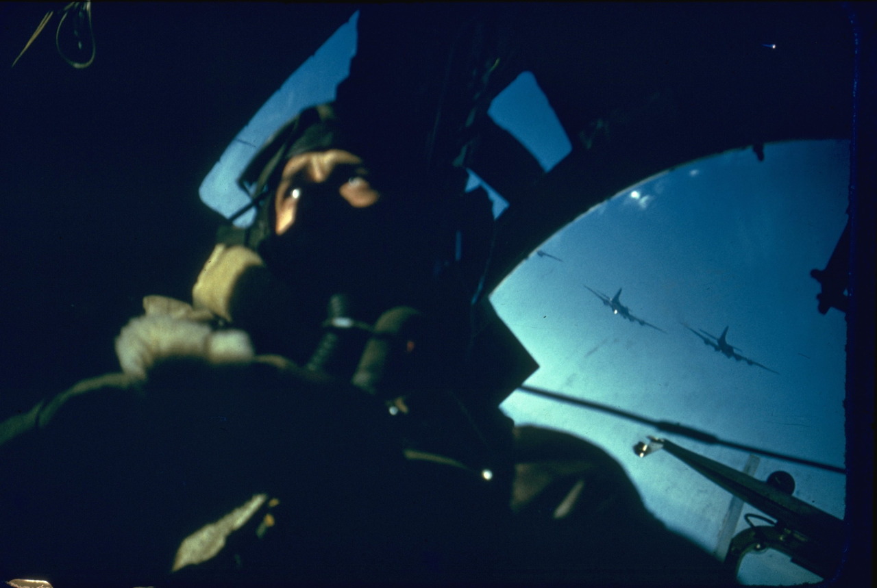 An incredibly rare, candid and original color photograph a B-17 bombardier heading toward Germany, 1940's.