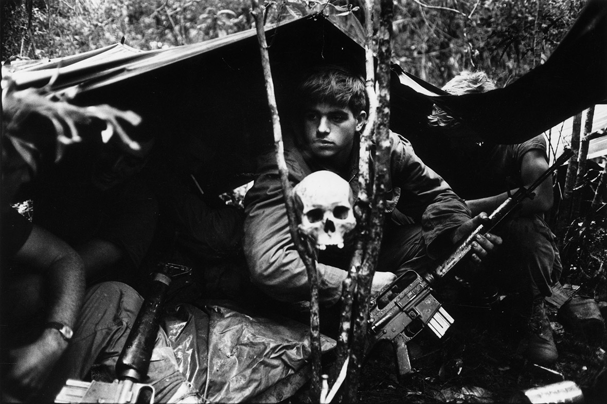 A human skull keeps watch over US soldiers encamped in the jungle during the Vietnam War, 25 October 1968.
