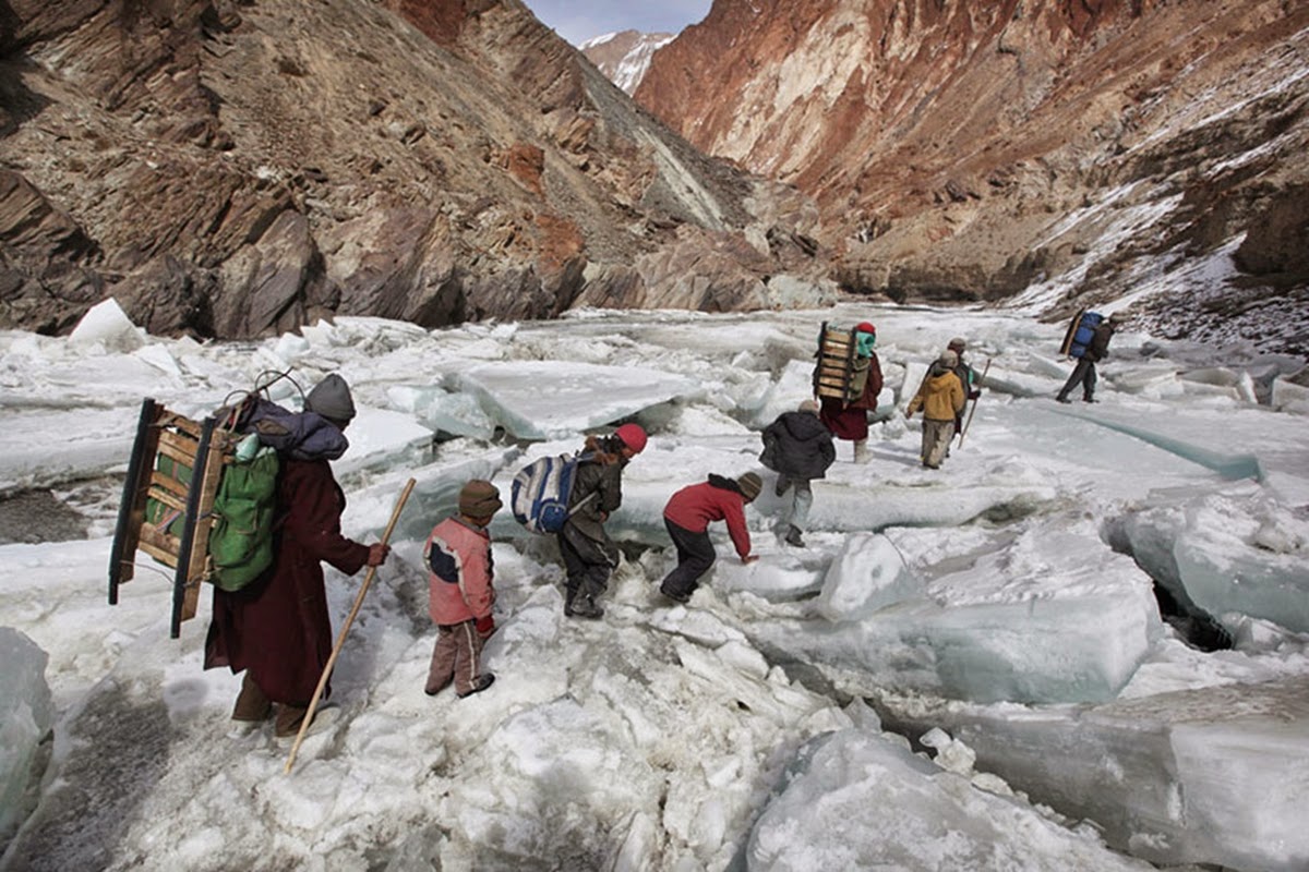 Kids traveling to a boarding school through The Himalayas. Zanskar, Indian Himalayas.