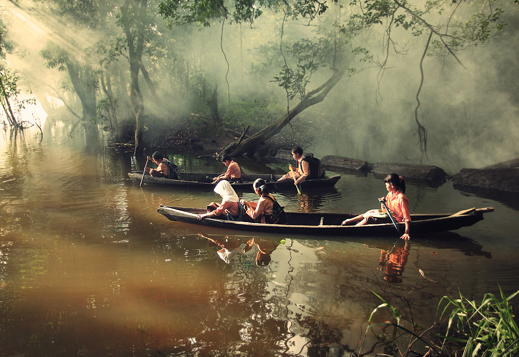 Pupils canoeing to school in Riau, Indonesia