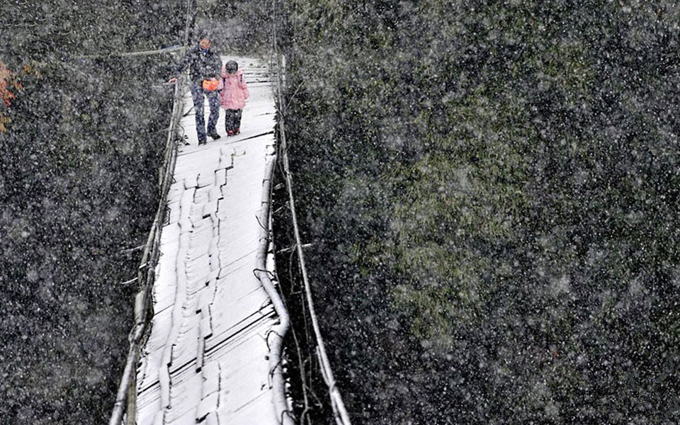 Crossing a Broken Bridge In The Snow To Get To School In Dujiangyan, Sichuan Province, China