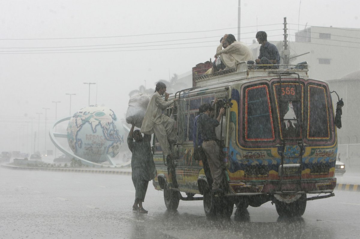 Heavy rain didn't deter these men in Karachi, Pakistan, seen riding on the outside of a bus.