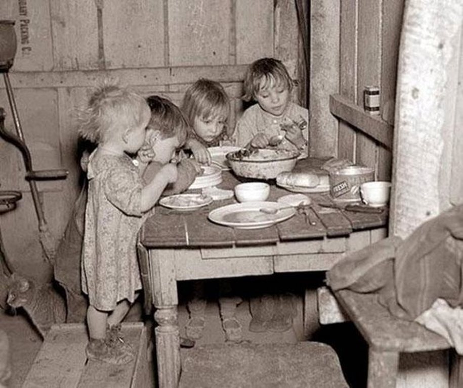 Children eating their Christmas dinner during the Great Depression. The meal was turnips and cabbage.