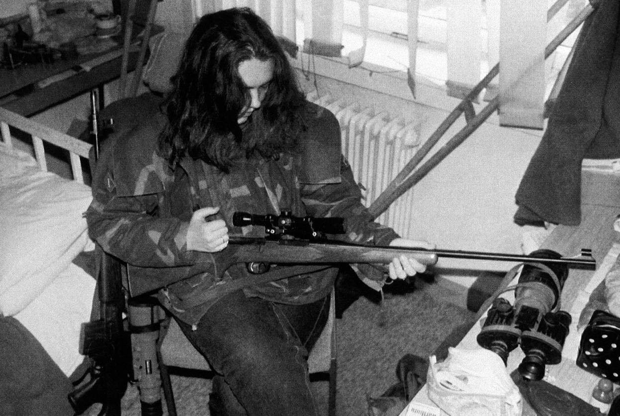 A top sniper, codenamed "Arrow," loads her gun in a safe room in Sarajevo, June 30, 1992. The 20-year-old Serb who shoots for the Bosnian forces says she has lost count of the number of people she has killed.