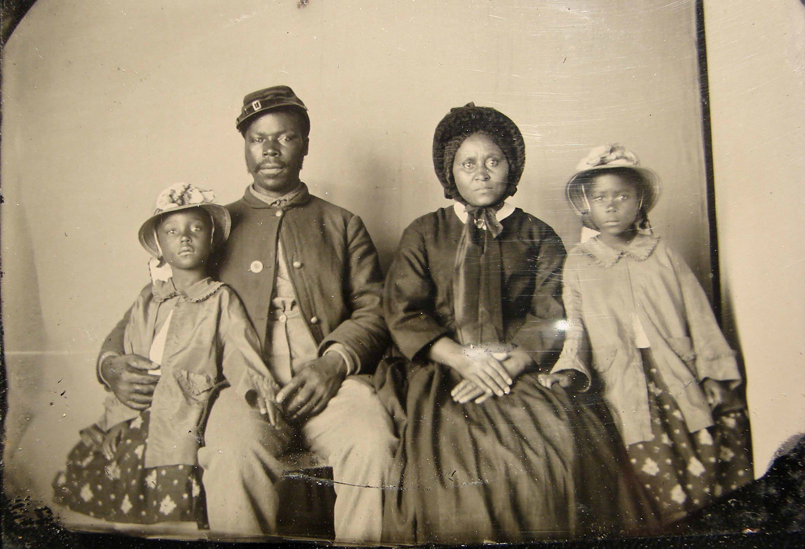 Unidentified African American soldier in Union uniform with wife and two daughters, between 1863-1865