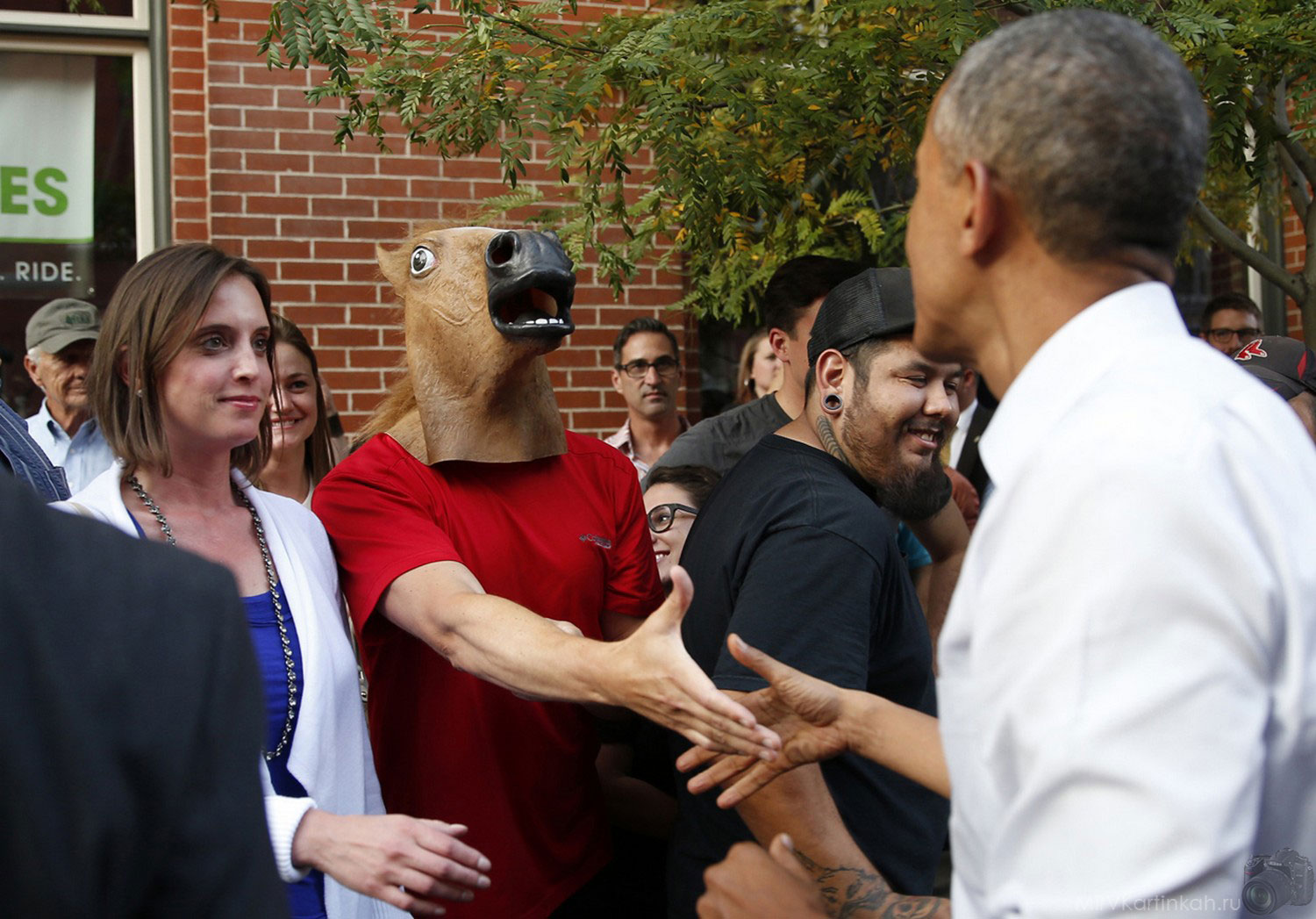 US President Barack Obama greets a man wearing a horse mask during a walkabout in Denver on July 8.