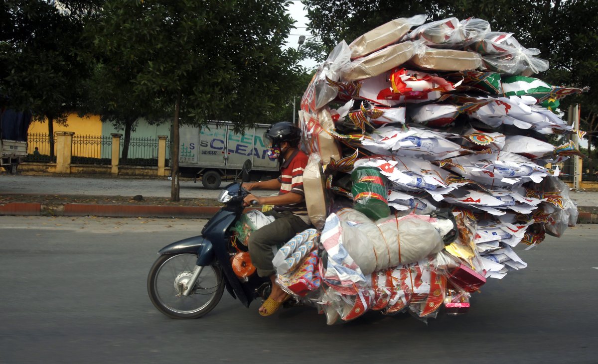 A man transports paper replicas of many items to be sold for the Vu Lan Festival in Vietnam. During the festival, Taoists and Buddhists believe that the living are supposed to please ghosts by offering food and burning paper effigies of daily items.