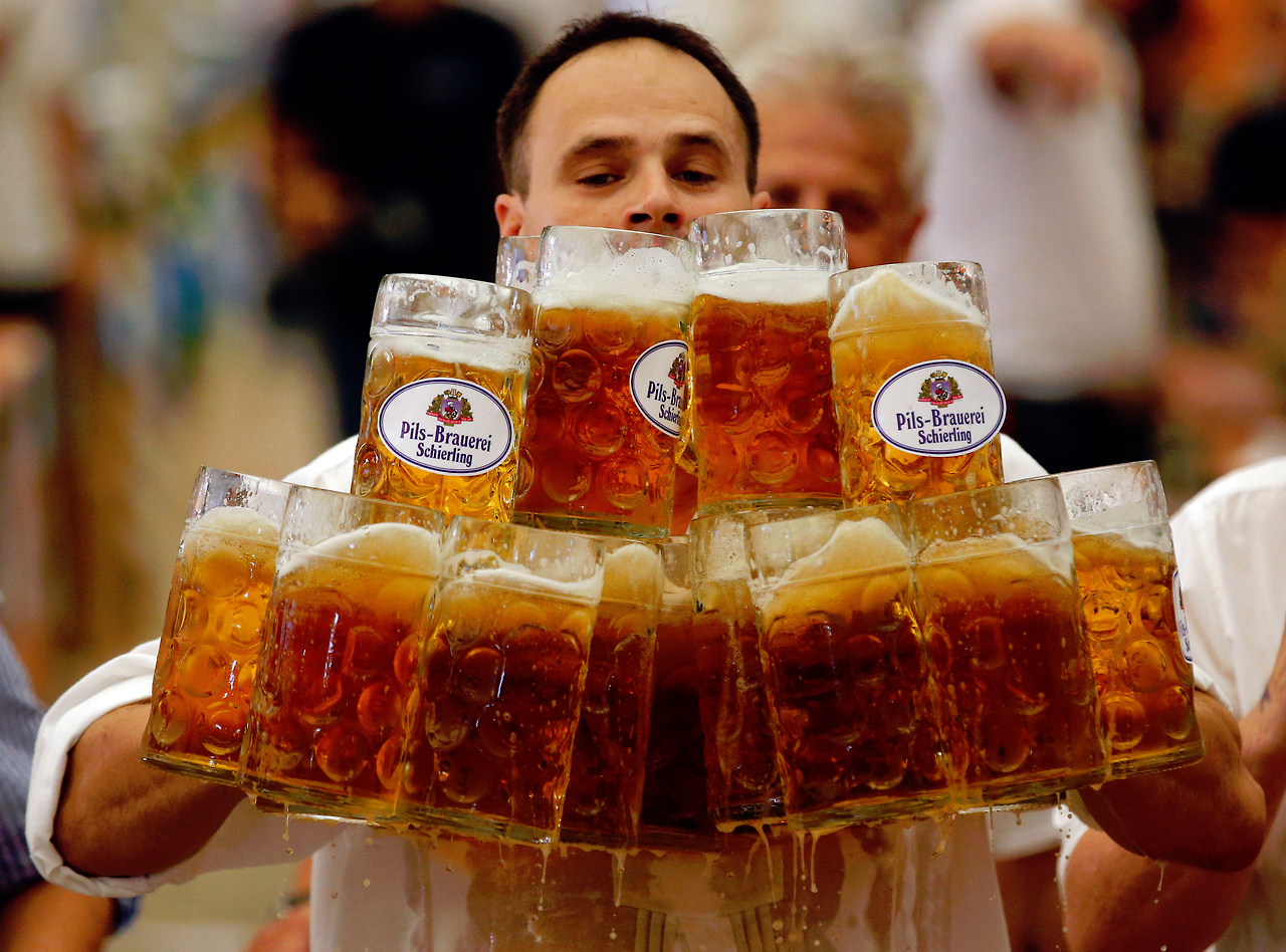 German Oliver Stuempfl competes to set a new world record for carrying one liter beer mugs over a distance of 131 feet on Sept. 7. Struempfl carried 27 mugs to set a new world record.