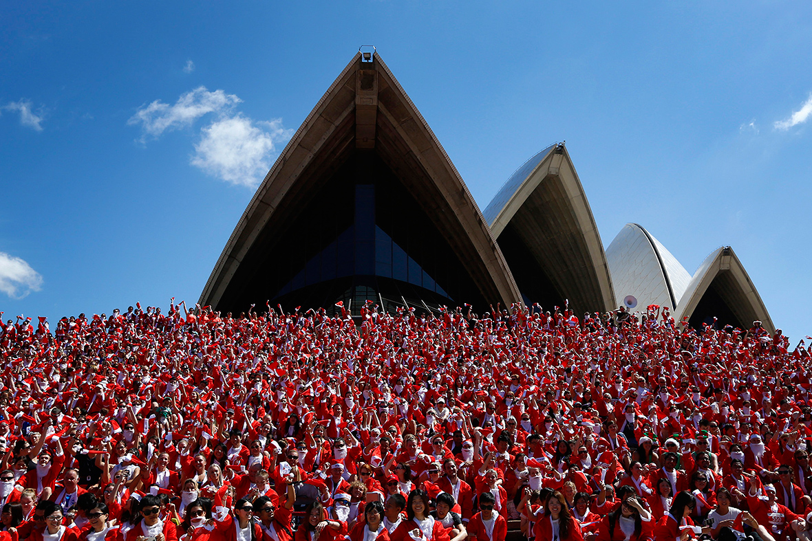 Thousands of runners in Santa suits pose for a group photo after completing an annual Santa fun run from Darling Harbour to the Sydney Opera House in Australia on Dec. 7. The annual event is held each year as a fundraiser to assist disadvantaged children with equipment and programs to help them live a fuller life.