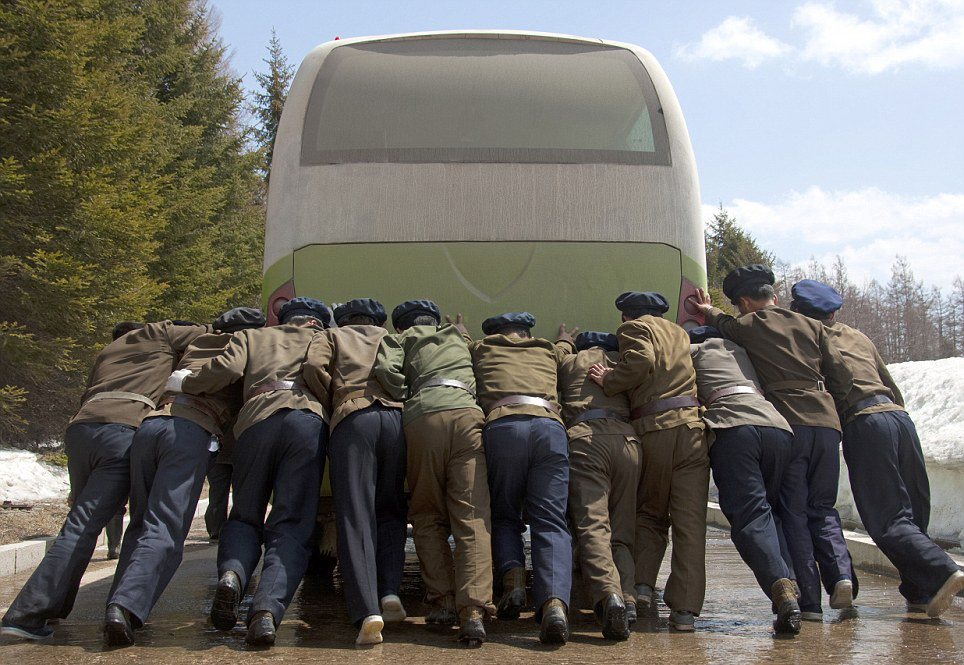 Photos of anything that doesn't work are forbidden. Here, riders push a broken bus.
