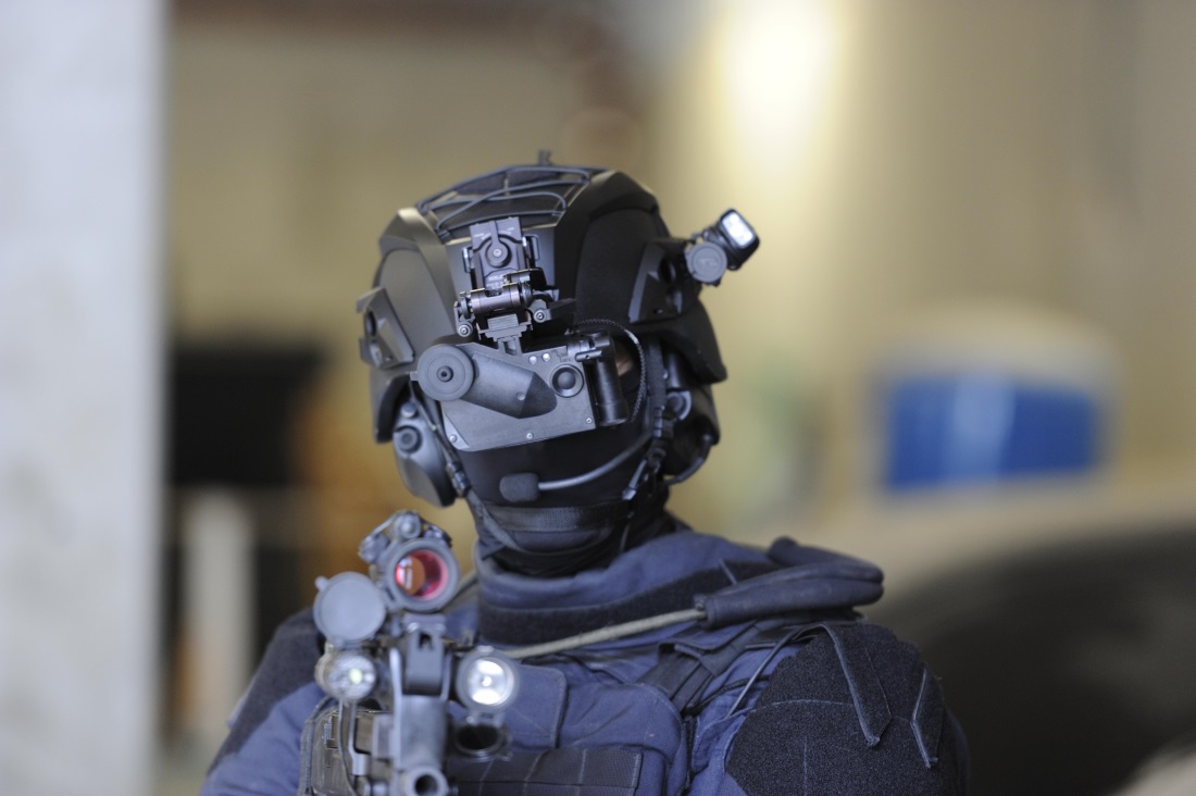 French Special Forces Operator, "GIGN"- The helmet is the MSA TC 500. Mounted on the front of the helmet is a Thales Group LUCIE Wide FOV Compact Night Vision Goggle. He is also wearing Peltor ComTac III Hearing Protection  Communications headset, and a Petzl STRIX headlamp with IR strobe.