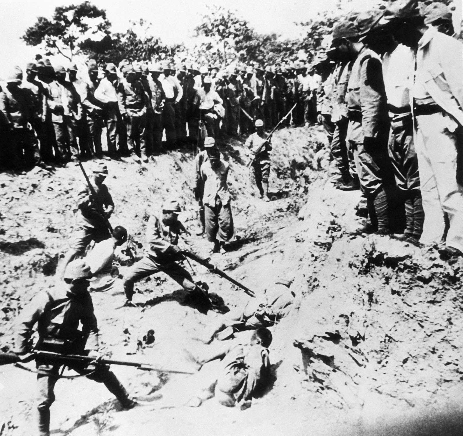 Chinese prisoners are used as live targets in a bayonet drill by their Japanese captors, during the Nanking Massacre, November 7, 1938.