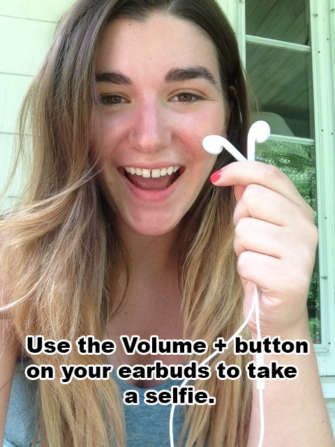 You can use the volume key on your phone or ear buds to take a picture.