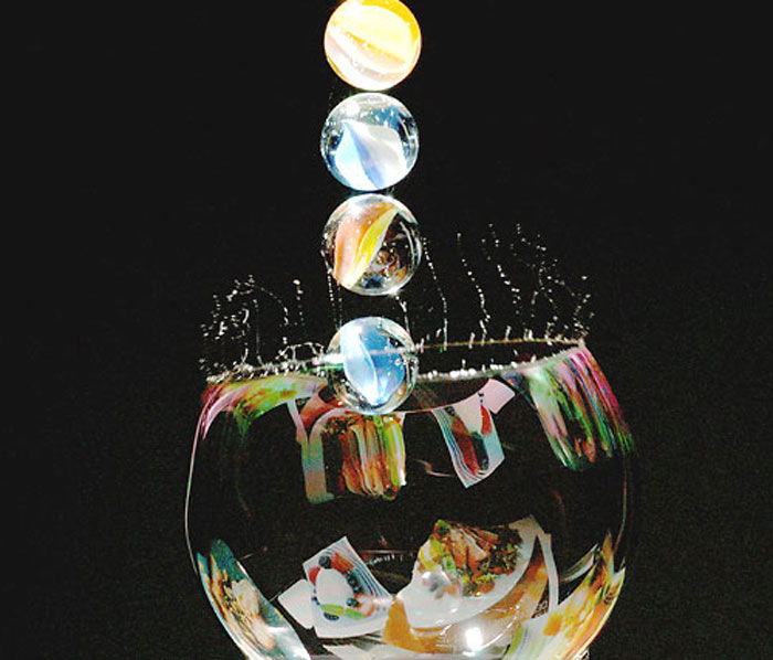 Marbles landing on a bubble