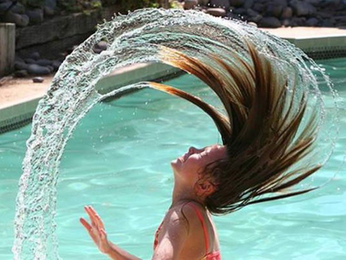 Girl flicks her wet hair back
