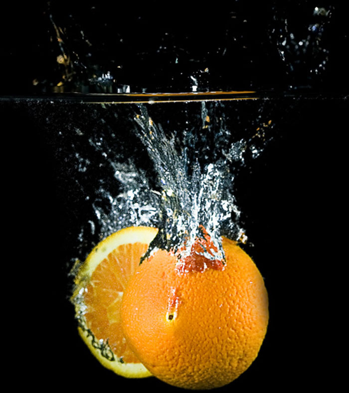 Sliced orange landing in water