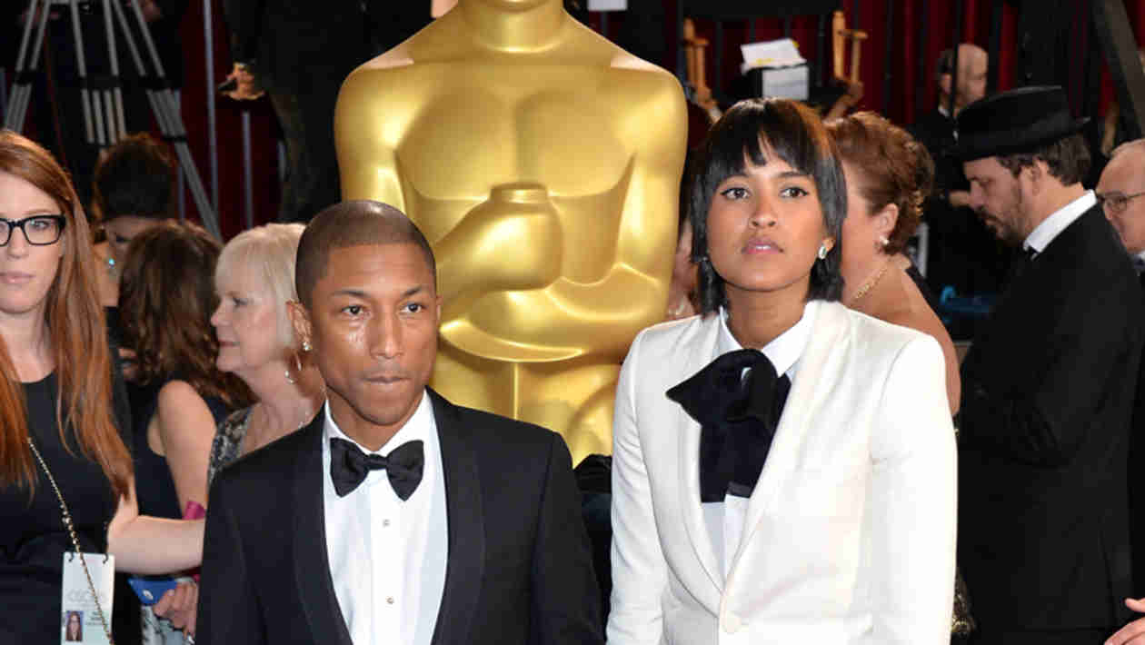 The Voice coach Pharrell Williams and his fashionista wife Helen Lasichanh are really only a couple of inches apart  Helen is 5'9" to Pharrell's 5'7". But Helen's usually wearing some killer heels, which only exaggerates their height difference! Somehow Pharrell's gigantic hat only highlights their height gap. Still, this "Happy" couple has some of our favorite red carpet fashion.