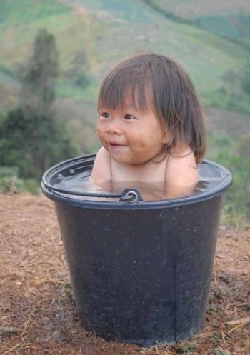 Baby girl likes a bath outside