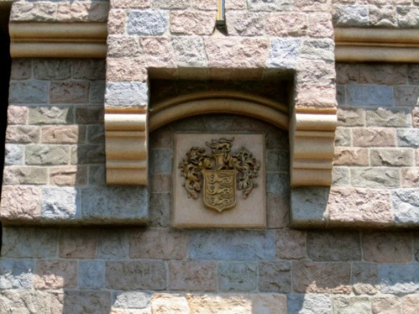 The Disney family crest is above the gates of Sleeping Beautys Castle. The crest was added in 1960 and is located directly above the drawbridge.