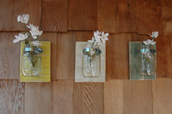 Mount them on the wall as vases for fresh flowers.