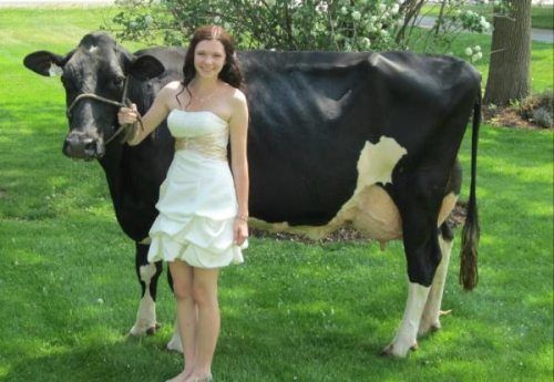 She is smiling because she has roofies for the cow.  Considering it's female, she isn't quite sure how, but she is losing that virginity tonight!