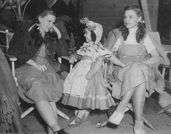 Judy Garland relaxing with Munchkin Olga Nardone and herbody double Bobbie Koshay on the set of The Wizard of Oz.