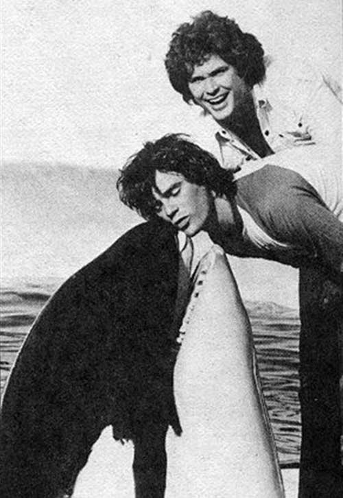 Richard Dean Anderson getting a kiss from a killer whalewith David Hasselhoff in the background.