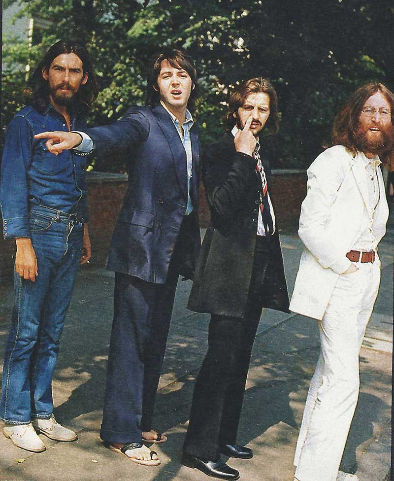 George Harrison, Paul McCartney, Ringo Starr and John Lennon waiting to cross Abbey Road during the shooting of the legendary album cover.