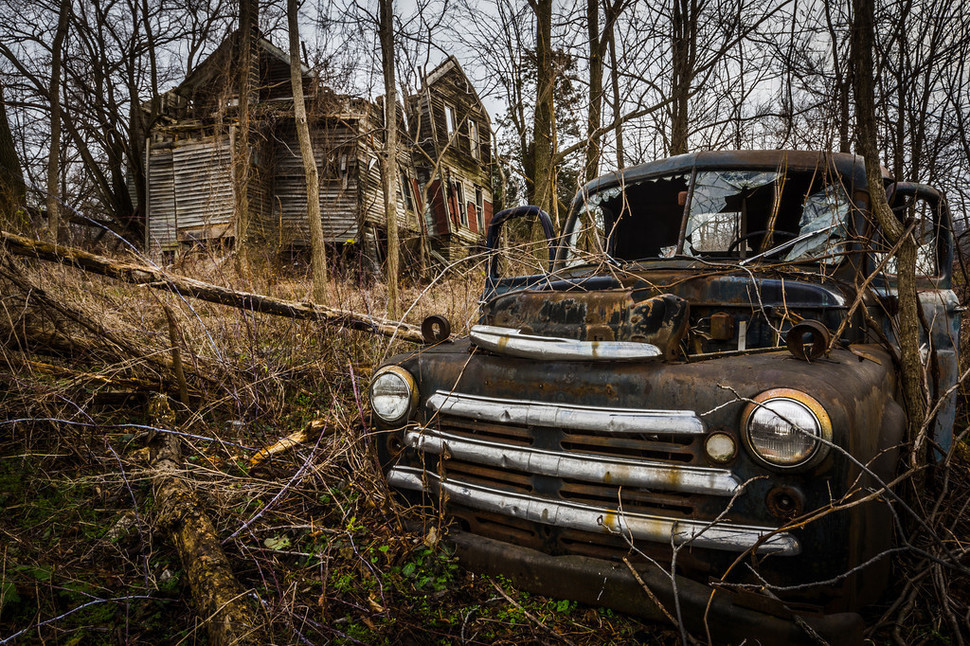 This abandoned farmhouse in Seneca Lake, New York, also acts as a graveyard for many vintage cars which are now empty shells of their former selves. New York, USA