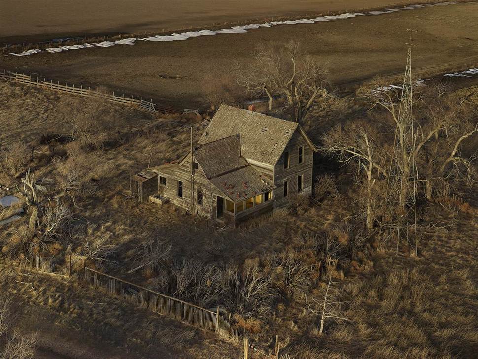 A decaying farmhouse amongst desolate fields. Sheridan County, Nebraska
