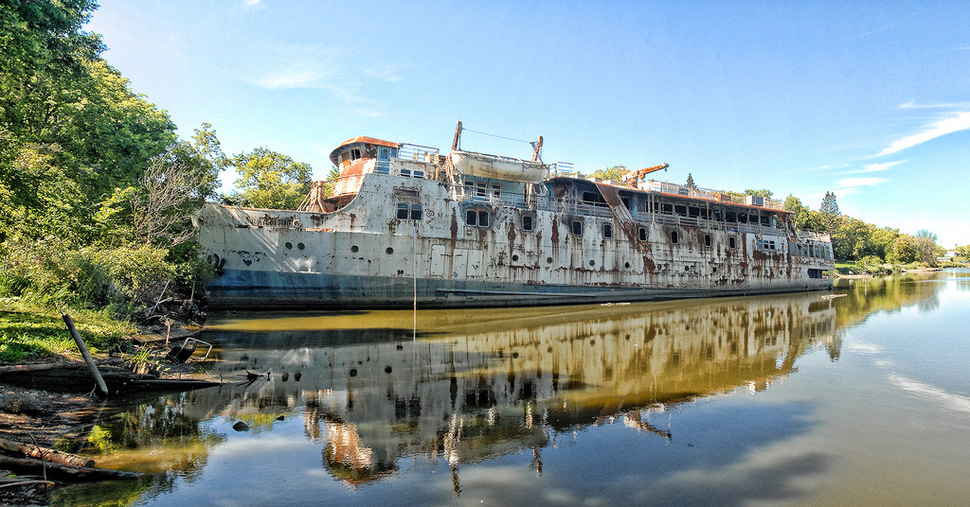 MS Lord Selkirk II Selkirk Slough, Manitoba, Canada -After being retired in 1990, MS Lord Selkirk II  was left at the end of a dock and all but forgotten. Years of neglect have seen this once extravagant cruise ship transform into what you see today.