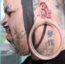 Kala Kaiwi, who unsurprisingly works as a tattoo and body modification artist, has earlobe stretches or 'flesh tunnels' measuring 109mm in diameter, to go with his hundreds of other body adaptations.
