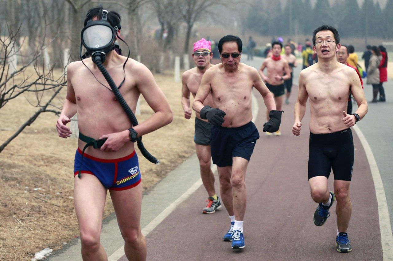 A participant wears a gas mask as he takes part in the “Guangzhu Naked Run” at the Olympic Forest Park in Beijing. The event is supposed to promote environmentally friendly lifestyles.