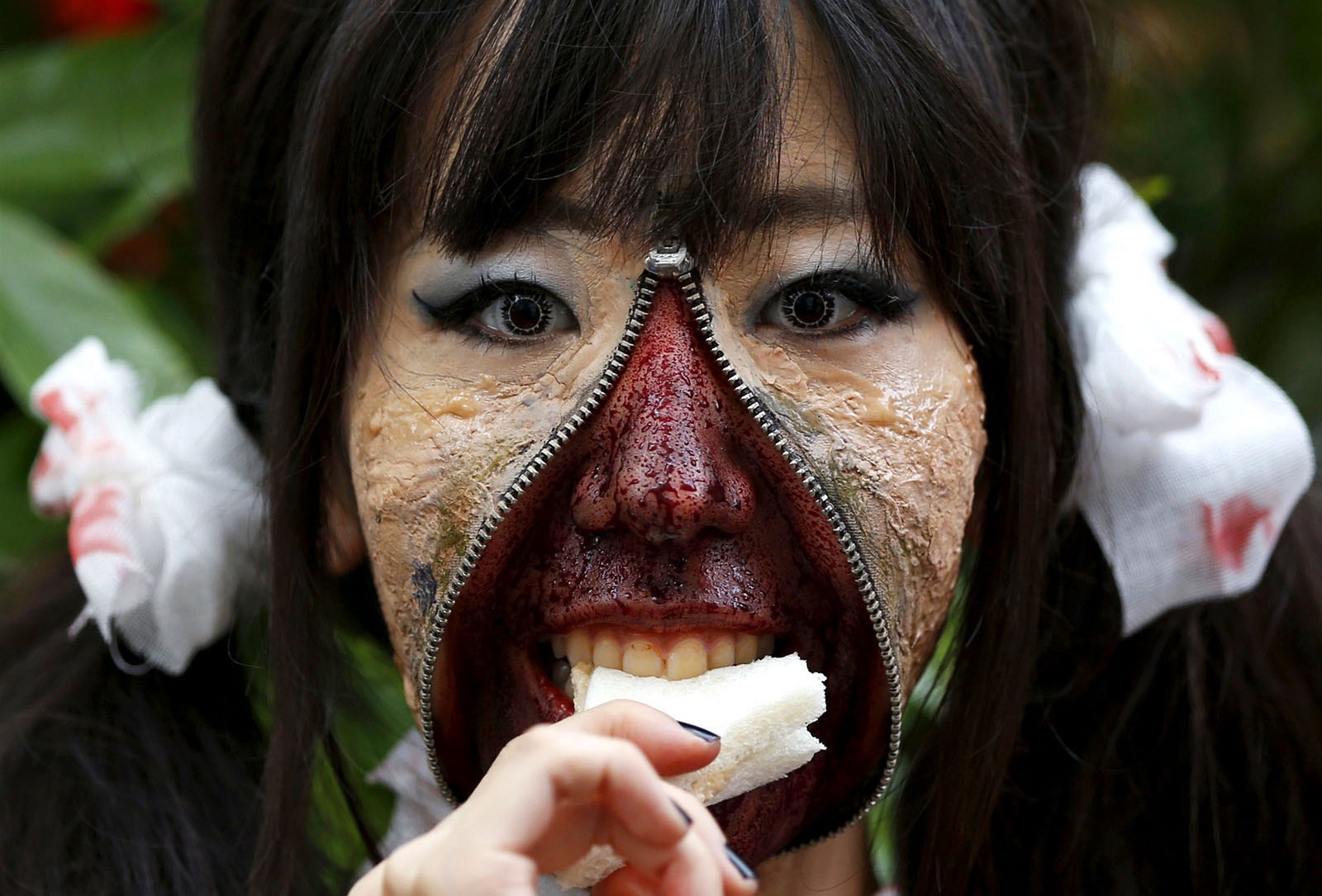 A participant eats a sandwich after a costume competition in Tokyo. More than 100,000 spectators turned up to watch the event.