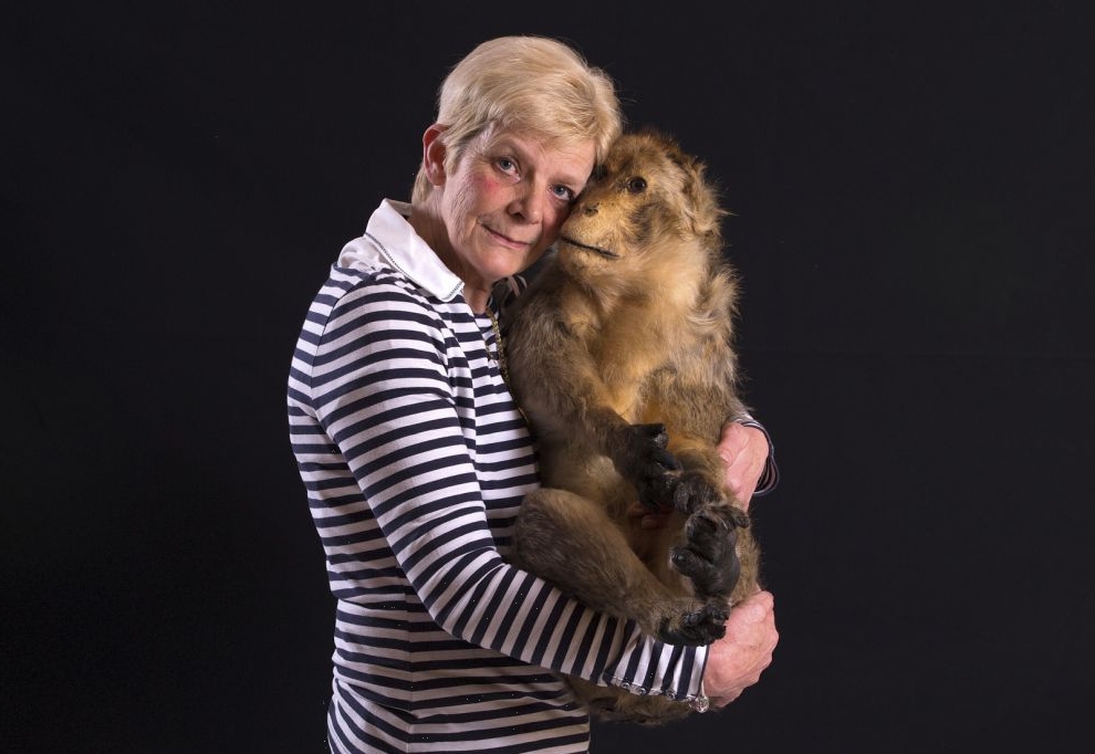 Chantal Bauchez poses with her stuffed barbary macaque, named Moukys, at her home in Rebecq, Belgium April 29, 2016. Pets are getting a high-class send-off at Animatrans, a funeral home that claims to be the first in Belgium to cater exclusively for pets.