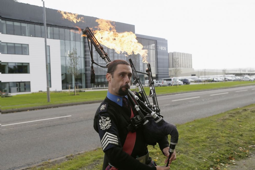 A man plays flaming bag pipes as opponents of fracking protest outside the offices of Ineos after they received the first shipment of shale gas to be delivered to the Britain at their Grangemouth terminal in Scotland