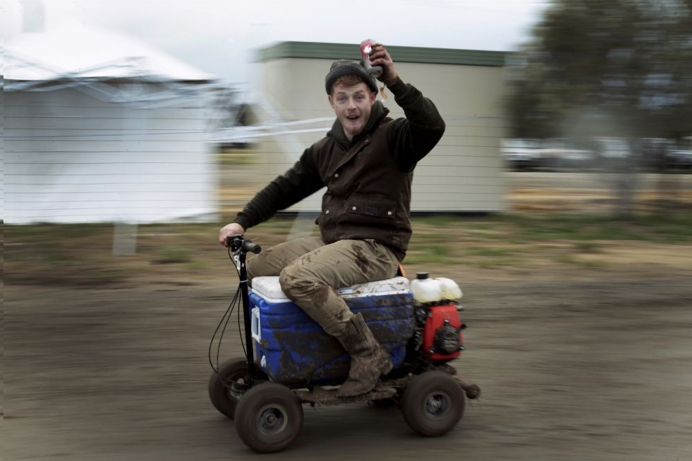 Sheep shearer Chris Kermond from Ballarat in the Australian state of Victoria rides a motorised 'esky' or drink cooler, while drinking a can of pre-mixed rum and cola at the Deni Ute Muster in Deniliquin, New South Wales, September 29, 2016.