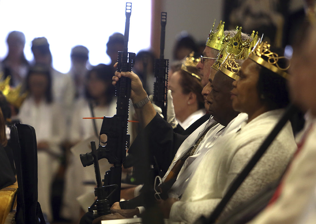 Sreymom Ouk, 41, who attended the ceremony with her husband, Sort Ouk, and came with their AR-15, said the weapon is useful for defending her family against "sickos and evil psychopaths."