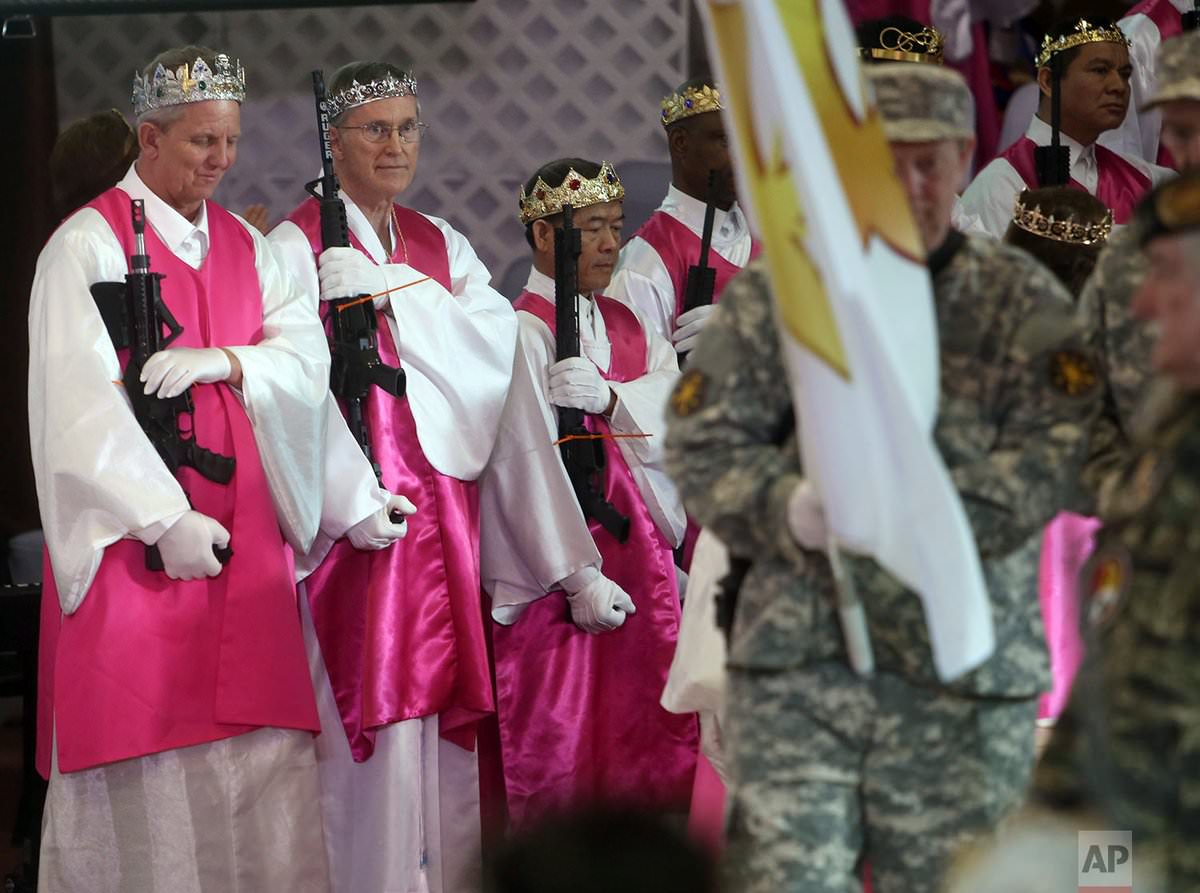 Religious Cult Members Wearing Bullet Adorned Crowns Hold A Ceremony For Their AR-15s