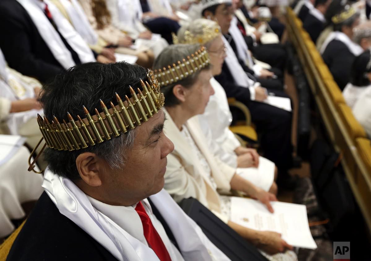 Religious Cult Members Wearing Bullet Adorned Crowns Hold A Ceremony For Their AR-15s