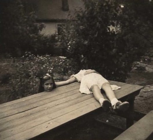 2 Sisters use the table to pretend one has been decapitated in 1920. Location unknown.