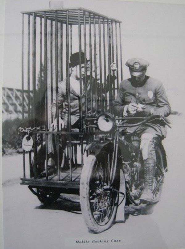 Transporting a prisoner somewhere in the US using a mobile holding cell attached to a motorcycle in 1921.