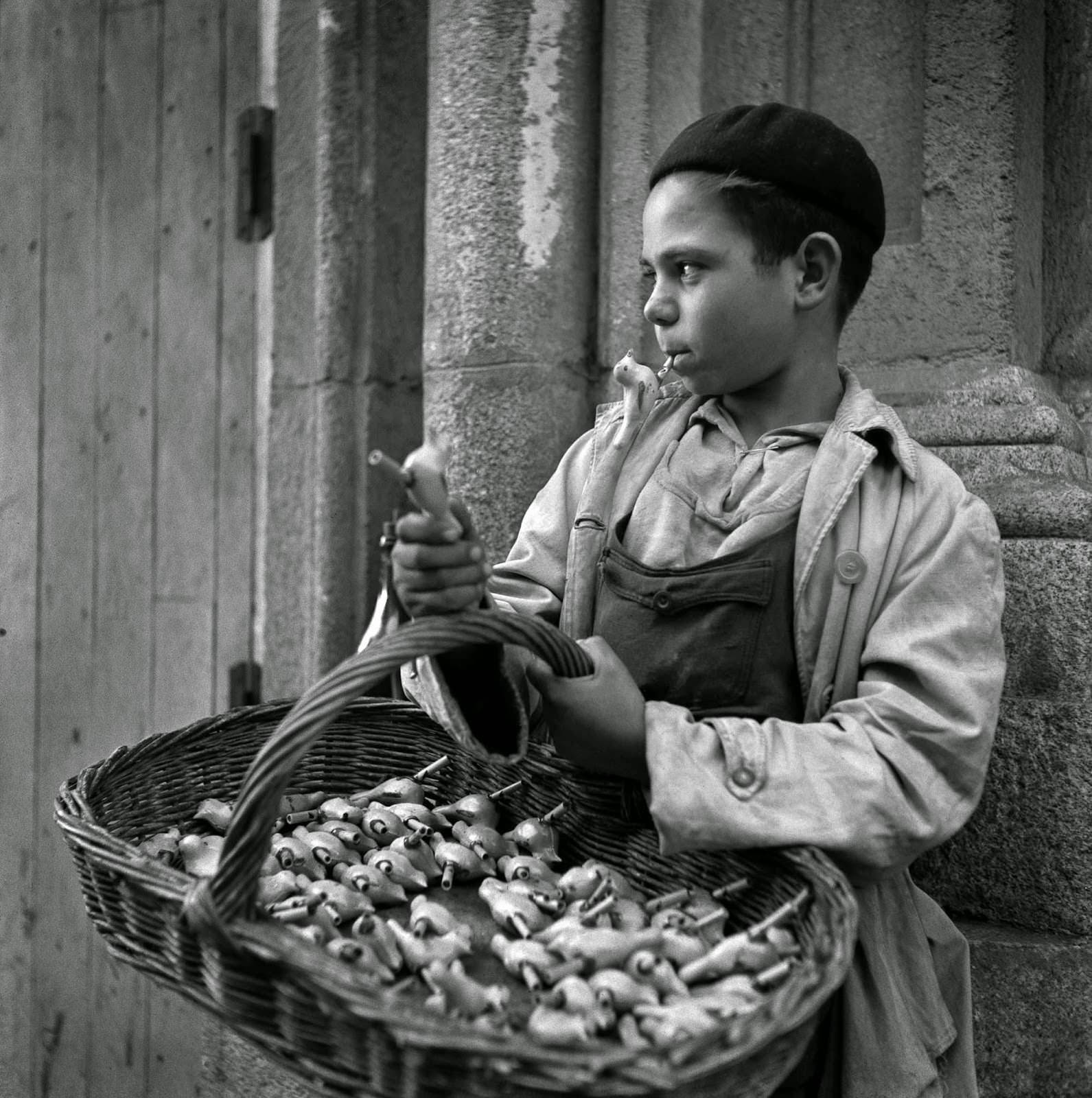 A boy selling bird whistles in Madrid, Spain in 1951.
