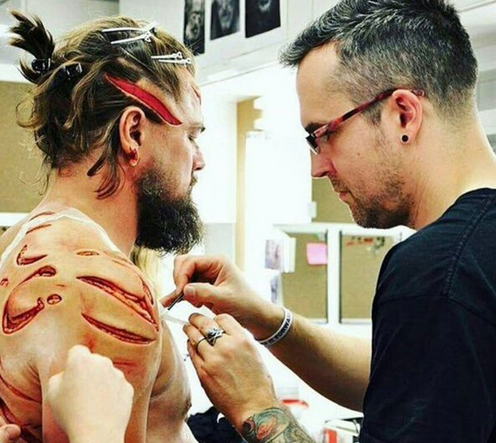 Leonardo DiCaprio having his makeup applied on the set of The Revenant.