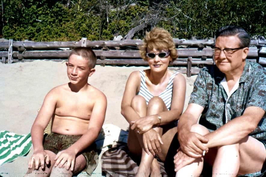 Tiny Martin Short with his parents during a lakeside beach vacation.