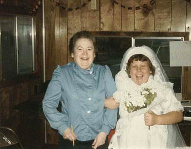 Goonies set studio teacher Rhoda C Fine with Chunk/ Jeff Cohen in a wedding dress, 1984/1985.